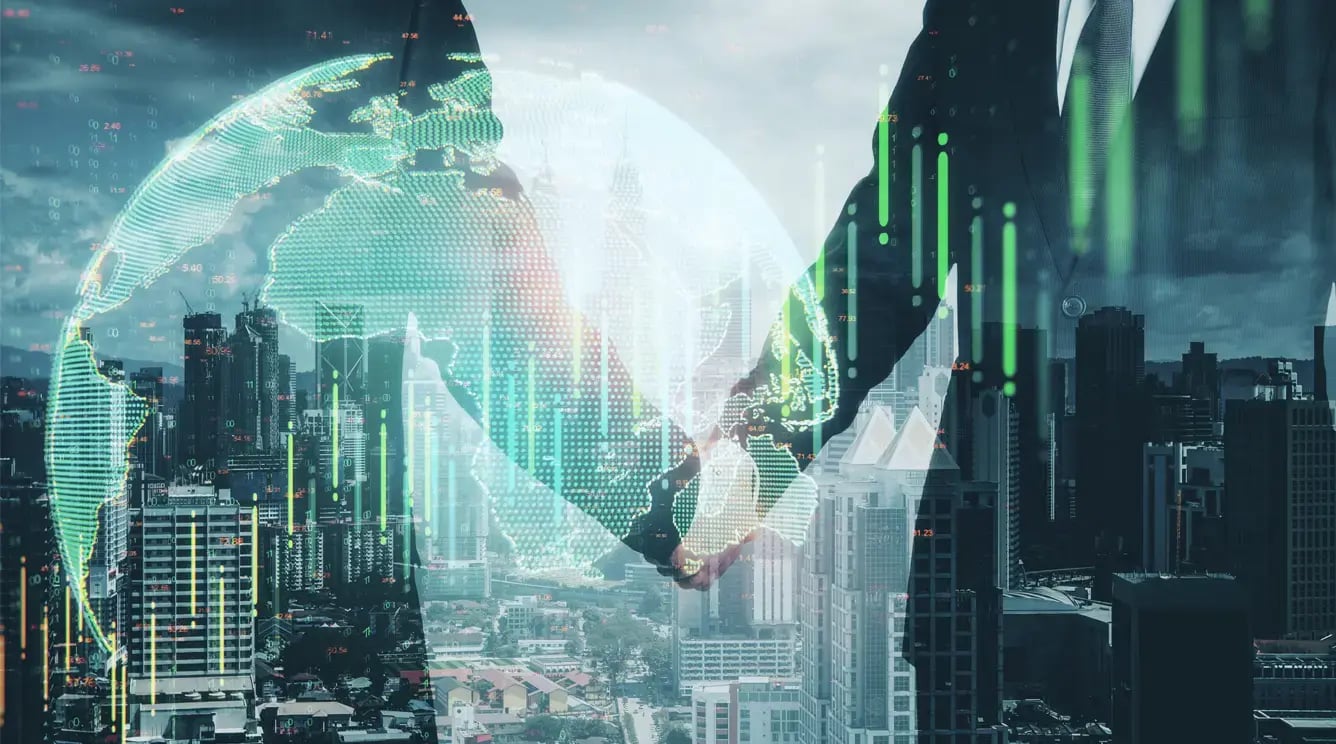 Businessmen shake hands with a city backdrop.