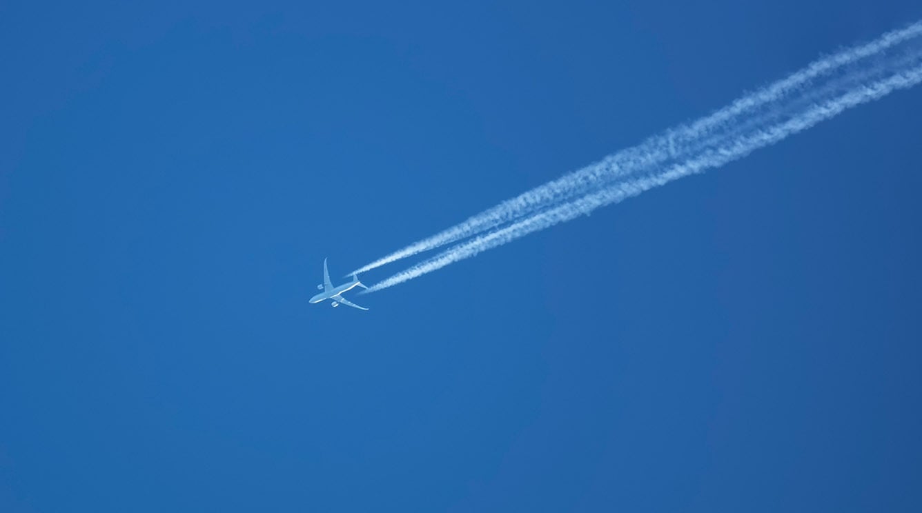 Airplane in the sky with contrails Airplane in the sky with contrails